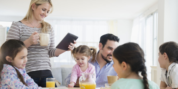 Caucasian family eating breakfast at table